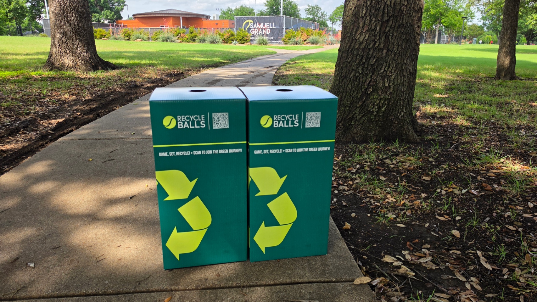 Two RecycleBalls bins on the walkway leading to Samuell Grand Tennis Center