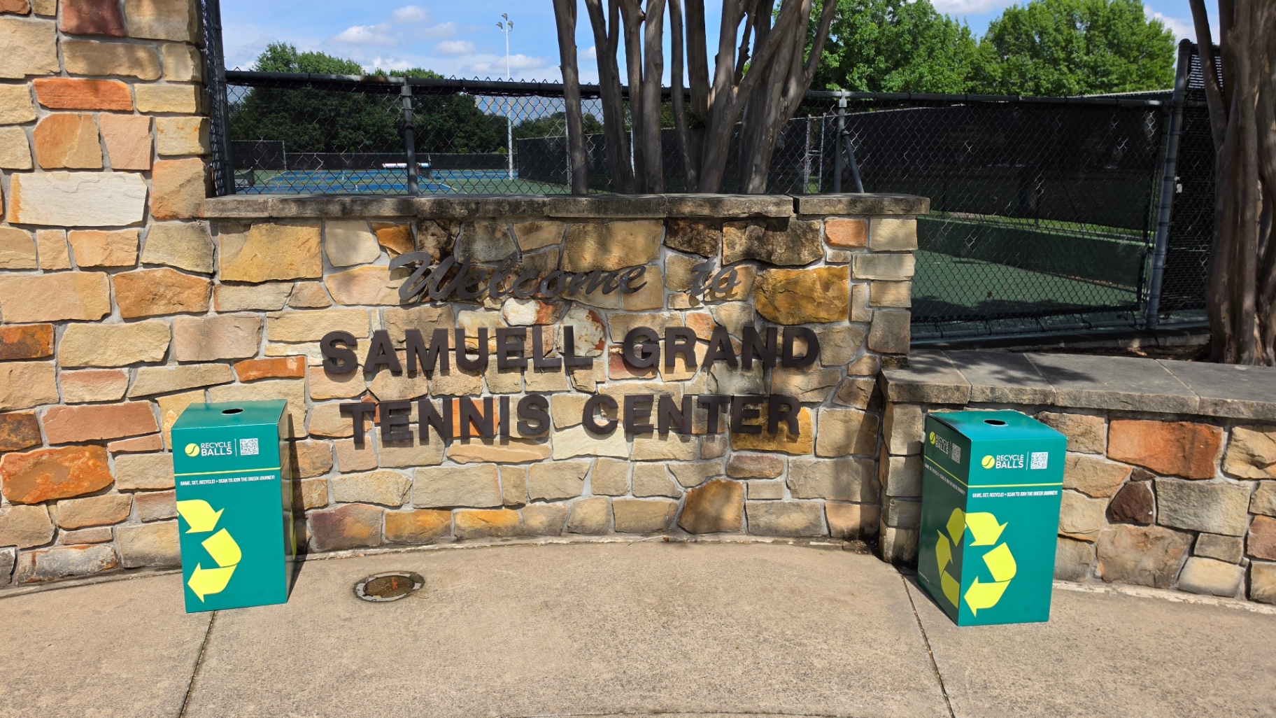 Two RecycleBalls bins placed at the Samuell Grand Tennis Center welcome sign