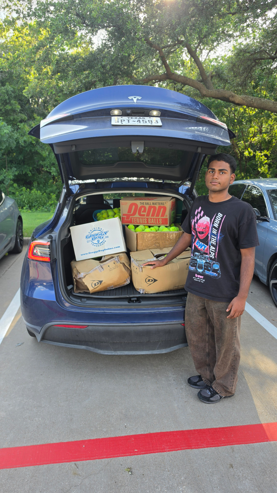 Trunk full of boxes of used tennis balls at the end of a pickup day