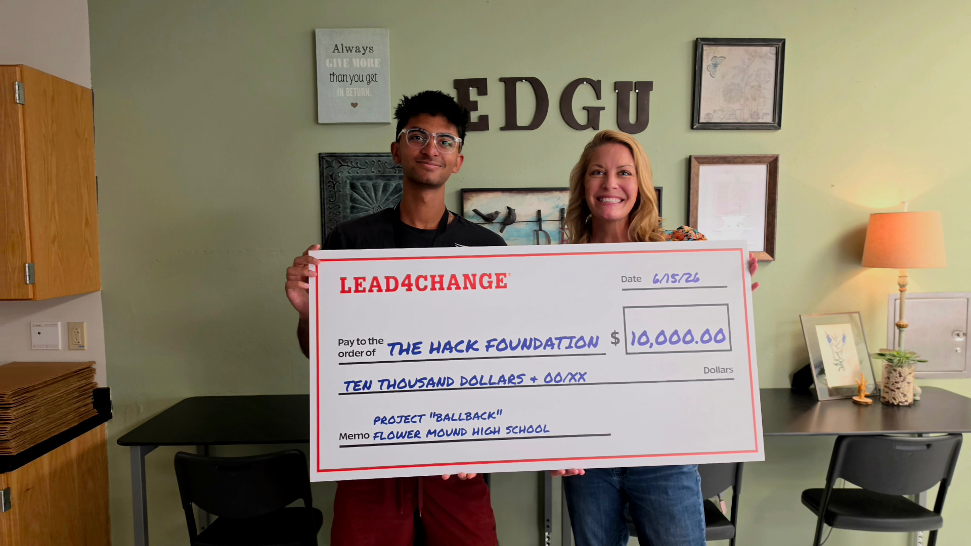 Prem Kamasani holding a Lead4Change check for $10,000 made out to The Hack Foundation for project BallBack
